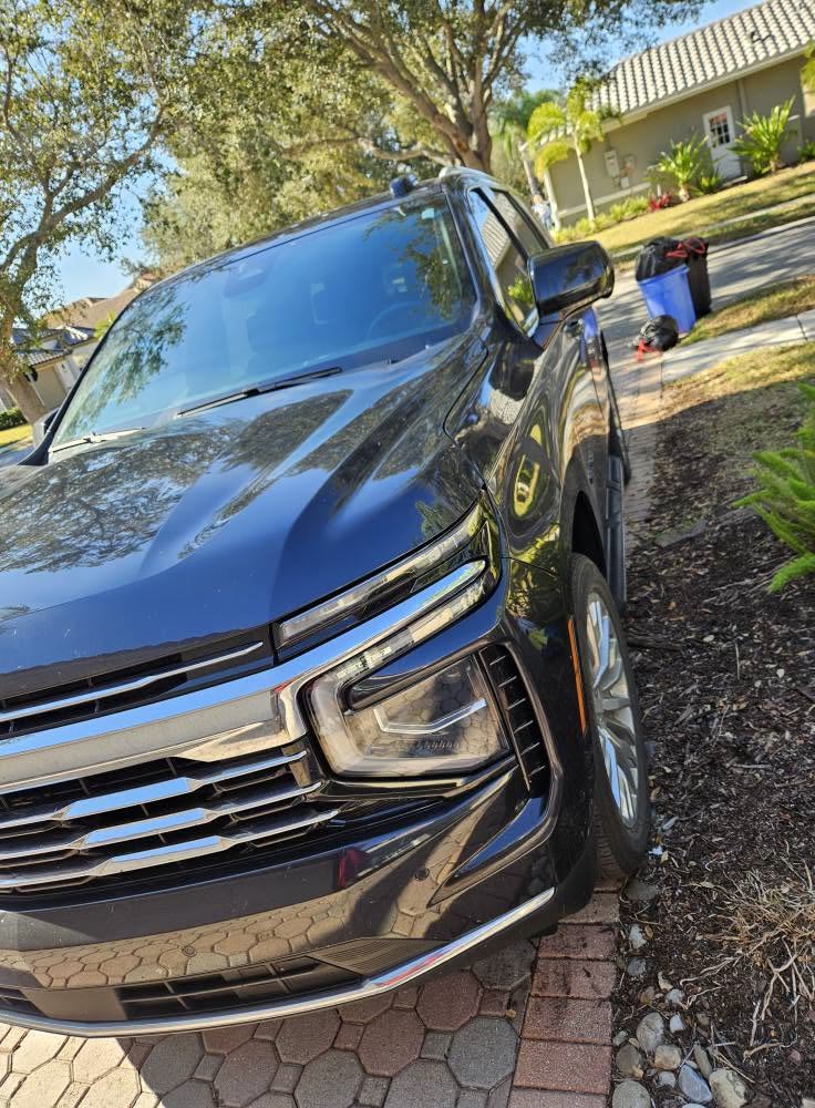Front of a dark Chevrolet SUV after a wash