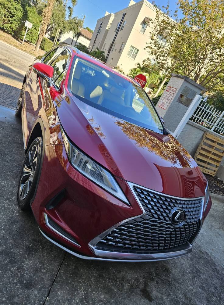 Red Lexus RX with a deep gloss after a wash