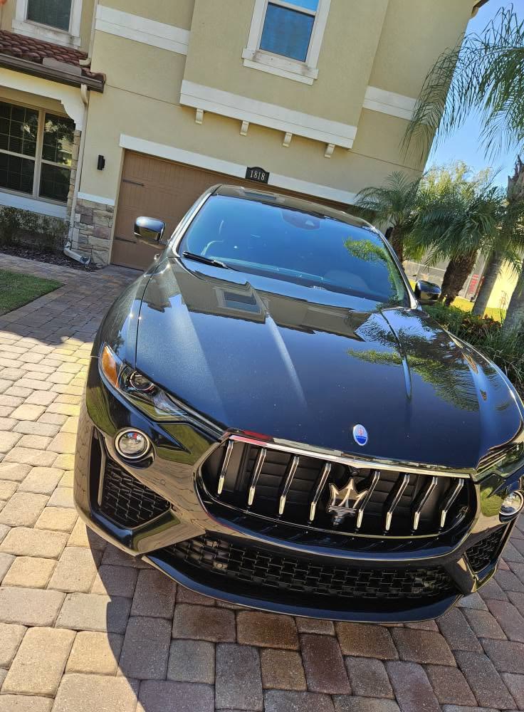 Black Maserati Levante, freshly detailed on a paver driveway