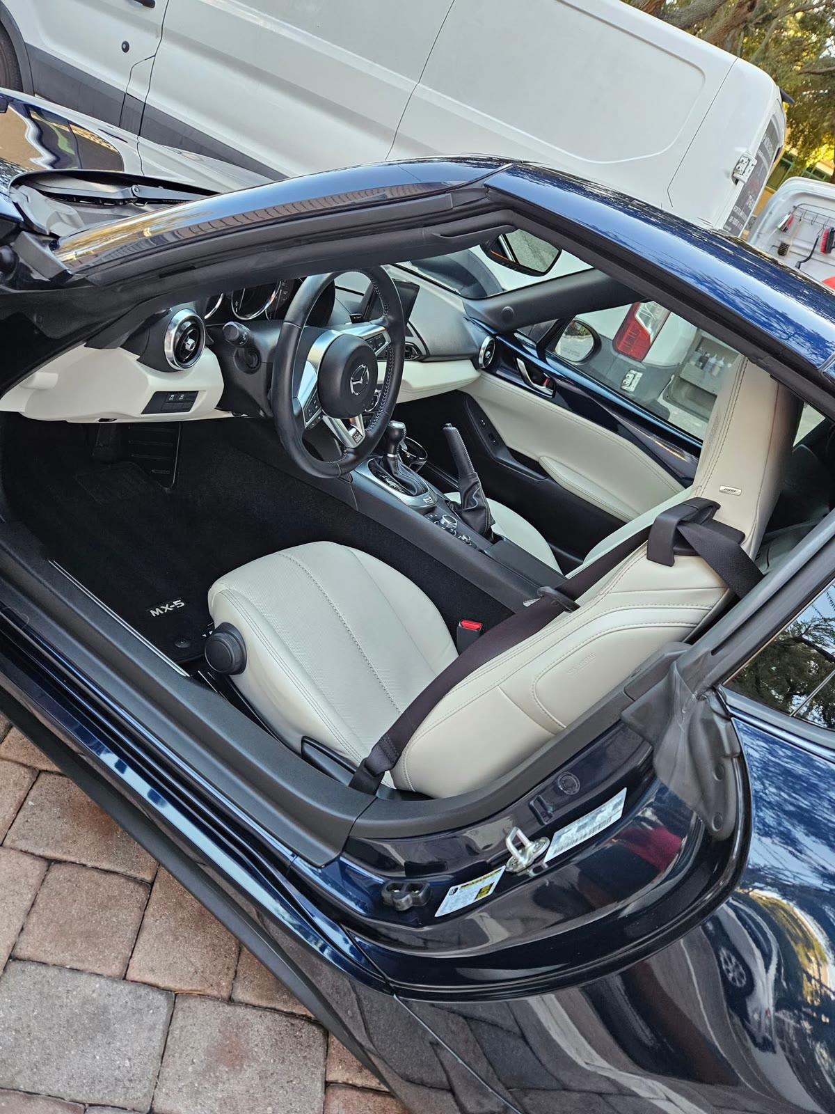 Mazda Miata cabin with clean white leather seats